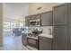 Modern kitchen featuring stainless steel appliances, grey cabinets, and quartz countertops at 4248 E Jason Dr, Phoenix, AZ 85050