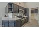 Well-lit kitchen featuring stainless steel appliances, open shelving, and a white backsplash at 4248 E Jason Dr, Phoenix, AZ 85050