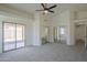 Carpeted main bedroom features backyard access, multiple mirrored closets, and access to bathroom at 4248 E Jason Dr, Phoenix, AZ 85050
