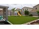 Lush backyard featuring artificial turf, playground, and manicured greenery at 4285 E Rousay Dr, San Tan Valley, AZ 85140