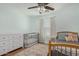 Tranquil bedroom with soft green walls, crib, and vintage-style rug, perfect for restful nights at 4285 E Rousay Dr, San Tan Valley, AZ 85140