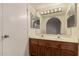 Bathroom featuring double sinks, wood cabinets, and a large mirror with vanity lighting at 4313 N 29Th Way, Phoenix, AZ 85016