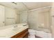 Bathroom with a sink and vanity with a frosted sliding glass door to tub and shower at 4313 N 29Th Way, Phoenix, AZ 85016