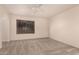 This bright bedroom has neutral carpet, a ceiling fan, and a large window with blinds at 4313 N 29Th Way, Phoenix, AZ 85016