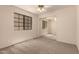 This bedroom features neutral carpet, a large window, and mirrored closet doors at 4313 N 29Th Way, Phoenix, AZ 85016