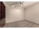 Bedroom features a ceiling fan, neutral carpet, and a built-in bookcase at 4313 N 29Th Way, Phoenix, AZ 85016