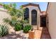 Charming stucco home entrance with tiled courtyard and a decorative wrought-iron security gate at 4313 N 29Th Way, Phoenix, AZ 85016
