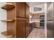 The kitchen has tiled floors, light wood cabinets, and a stainless-steel refrigerator at 4313 N 29Th Way, Phoenix, AZ 85016