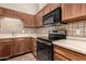 Traditional kitchen features wood cabinets, decorative backsplash, and modern stainless-steel appliances at 4313 N 29Th Way, Phoenix, AZ 85016