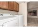 This laundry room has a washer and dryer and cabinets above at 4313 N 29Th Way, Phoenix, AZ 85016