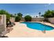 A backyard pool with seating and mature landscaping for privacy at 4313 N 29Th Way, Phoenix, AZ 85016