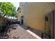 Side view of the backyard with desert landscaping, a patio, and grill at 451 S Hawes Rd # 53, Mesa, AZ 85208