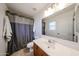 Bathroom showcasing a single sink vanity, toilet, shower-tub combo, and a large mirror at 451 S Hawes Rd # 53, Mesa, AZ 85208