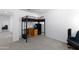 A well-lit bedroom showcasing a black metal bunk bed with an adjacent desk, ideal for study and relaxation at 451 S Hawes Rd # 53, Mesa, AZ 85208