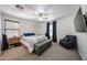 Carpeted bedroom featuring large windows, ceiling fan and decorative chair at 451 S Hawes Rd # 53, Mesa, AZ 85208