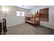 Cozy bedroom featuring a wooden bunk bed, carpet flooring, two windows with blinds and a neutral color scheme at 451 S Hawes Rd # 53, Mesa, AZ 85208
