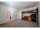 Neutral carpeted bedroom featuring loft bed, desk, and adjoining bathroom at 451 S Hawes Rd # 53, Mesa, AZ 85208