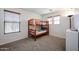 Cozy bedroom features a wooden bunk bed, carpet flooring, two windows with blinds and a neutral color scheme at 451 S Hawes Rd # 53, Mesa, AZ 85208