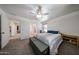 Carpeted bedroom featuring large windows, ceiling fan and walk-in closet at 451 S Hawes Rd # 53, Mesa, AZ 85208