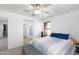 Bright bedroom with ceiling fan, blue bedding, and carpet flooring at 451 S Hawes Rd # 53, Mesa, AZ 85208
