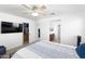 Spacious bedroom featuring a ceiling fan, TV, and walk in closet at 451 S Hawes Rd # 53, Mesa, AZ 85208