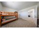 Neutral-toned bedroom with a wooden bunk bed and doorway leading to another room at 451 S Hawes Rd # 53, Mesa, AZ 85208