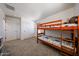 Bedroom features carpet flooring, wooden bunk bed, two windows and a closet at 451 S Hawes Rd # 53, Mesa, AZ 85208