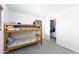 Bedroom with a wood bunk bed frame and a closet door, with a neutral toned carpet at 451 S Hawes Rd # 53, Mesa, AZ 85208