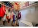 Walk-in closet with built-in shelves, clothes hanging on rods, and storage boxes at 451 S Hawes Rd # 53, Mesa, AZ 85208