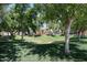 A community park with mature trees, a playground, and green space at 451 S Hawes Rd # 53, Mesa, AZ 85208