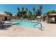 The community pool features lounge chairs, shaded seating, and well-maintained landscaping at 451 S Hawes Rd # 53, Mesa, AZ 85208