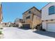 Three-story stucco townhouse features an attached garage and well-maintained landscaping at 451 S Hawes Rd # 53, Mesa, AZ 85208