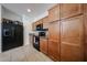 Well-lit kitchen featuring wood cabinets, black appliances, and tile flooring at 451 S Hawes Rd # 53, Mesa, AZ 85208