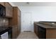 Well-lit kitchen with brown cabinets, granite countertops, and modern appliances at 451 S Hawes Rd # 53, Mesa, AZ 85208