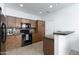 Well-lit kitchen equipped with modern appliances, wooden cabinetry, and ample counter space for cooking at 451 S Hawes Rd # 53, Mesa, AZ 85208