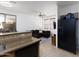 Open-concept layout with kitchen featuring a breakfast bar and a view of the living room with comfortable seating at 451 S Hawes Rd # 53, Mesa, AZ 85208