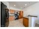 Well-equipped kitchen with black appliances, granite counters, and wooden cabinets at 451 S Hawes Rd # 53, Mesa, AZ 85208