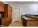 Well-equipped kitchen with black appliances, granite counters, and wooden cabinets at 451 S Hawes Rd # 53, Mesa, AZ 85208