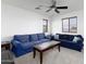 Spacious living room with plush blue sofas and a wood coffee table, perfect for relaxation and gatherings at 451 S Hawes Rd # 53, Mesa, AZ 85208