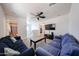 Large living room featuring neutral carpet, ceiling fan, modern furniture, flat screen, and open floor plan at 451 S Hawes Rd # 53, Mesa, AZ 85208