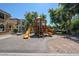 Community playground area with slides, climbing structures, and soft landing surfaces at 451 S Hawes Rd # 53, Mesa, AZ 85208