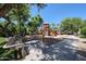 View of the community playground featuring swings, slides, benches and covered picnic area at 451 S Hawes Rd # 53, Mesa, AZ 85208