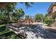 Exterior shot of the community playground with climbing equipment, swings, and seating area at 451 S Hawes Rd # 53, Mesa, AZ 85208