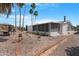 Well-maintained backyard features palm trees and a gravel landscape, offering a serene outdoor space at 5402 E Mckellips Rd # 237, Mesa, AZ 85215