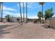 Expansive backyard features a pergola, palm trees and a gravel landscape, offering a serene outdoor space at 5402 E Mckellips Rd # 237, Mesa, AZ 85215