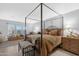 Bedroom features a four-poster bed, sitting area, and wood floors at 5402 E Mckellips Rd # 237, Mesa, AZ 85215
