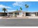 Charming exterior of a well-maintained home with carport, manicured landscaping, and palm trees at 5402 E Mckellips Rd # 237, Mesa, AZ 85215