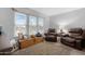 Bright living room featuring large windows, comfortable leather chairs, and a cozy atmosphere at 5402 E Mckellips Rd # 237, Mesa, AZ 85215