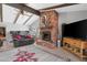 Open living room boasts a brick fireplace, exposed beams, ceiling fan, and expansive area for entertaining at 5402 E Mckellips Rd # 237, Mesa, AZ 85215