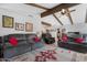 Spacious living room features vaulted ceilings, exposed beams, ceiling fan, and comfortable seating arrangements at 5402 E Mckellips Rd # 237, Mesa, AZ 85215